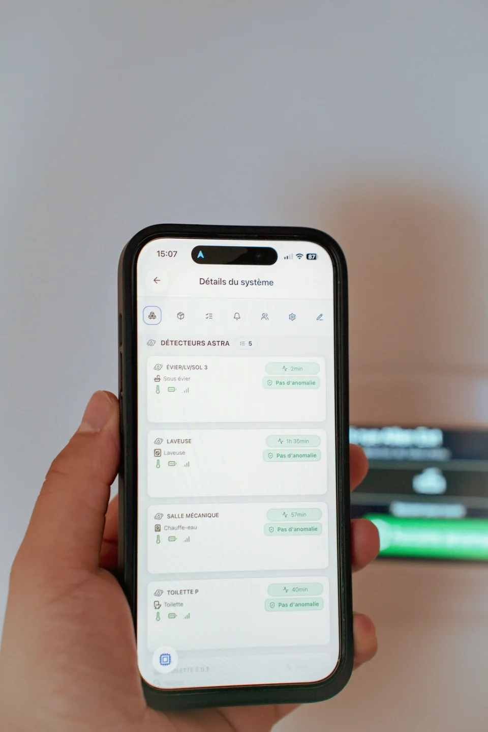 Astra mobile app open on a phone held in hand