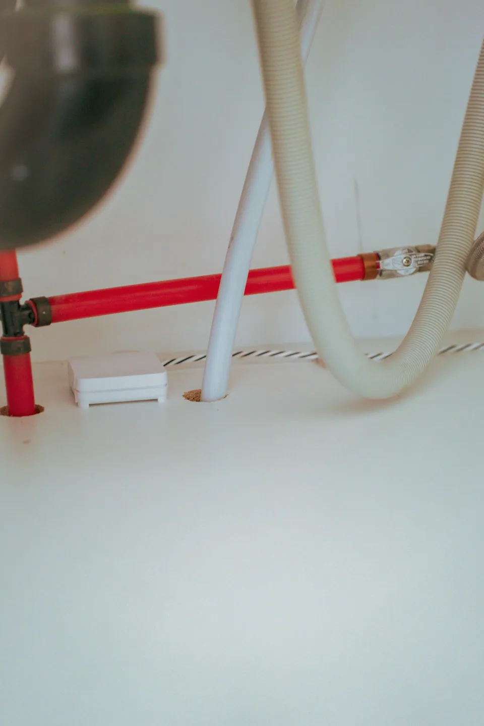 Astra Sensor positioned beneath appliance plumbing