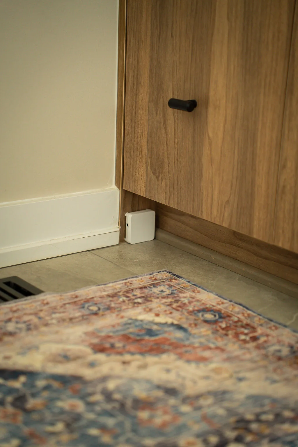 Astra Sensor installed at floor level beside built-in cabinetry